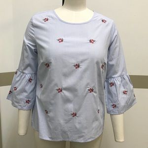 Light blue top with delicate flower embroidery